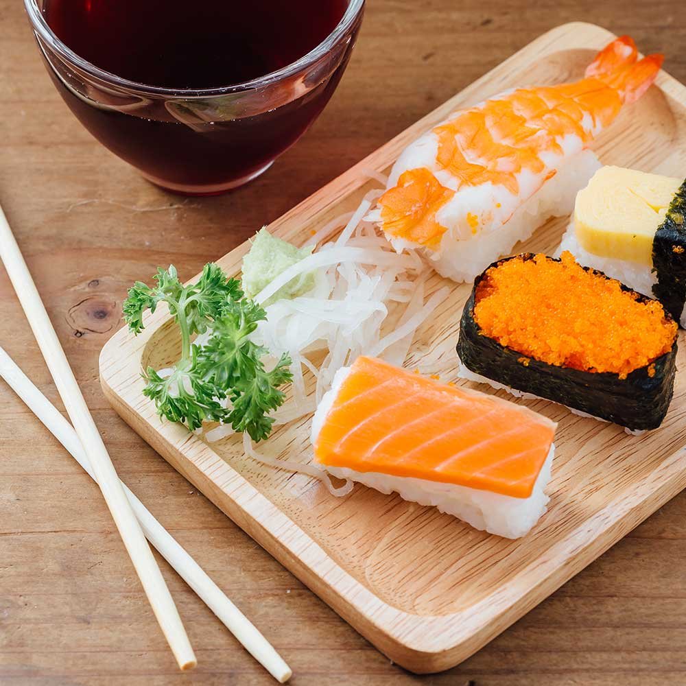 sushi-set-on-wooden-table-with-healthy-water-PKMHZ2E.jpg